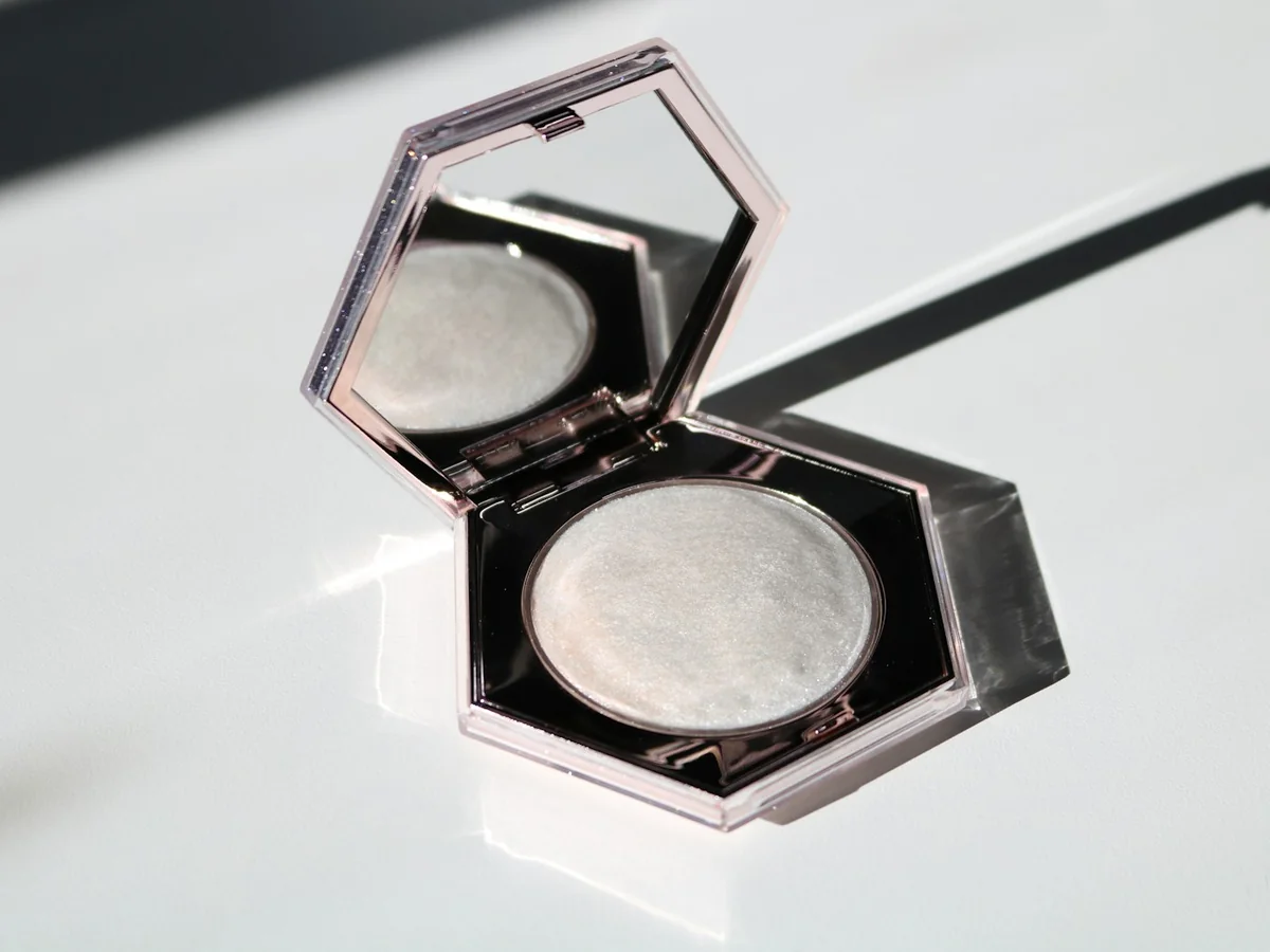 Representative cosmetics store photography for the fictional product Dew Finish Highlighter