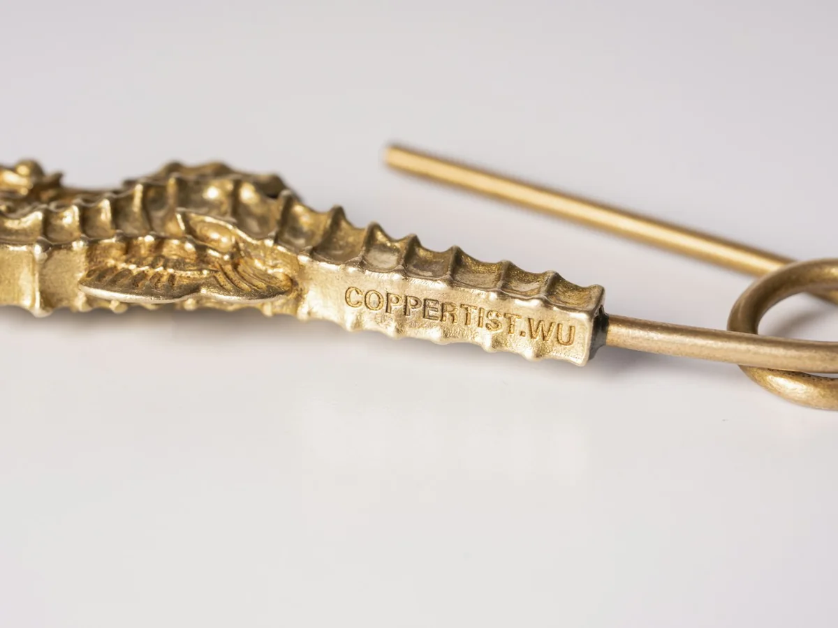 Representative fashion accessories photography for the fictional product Sculpted Collar Pin