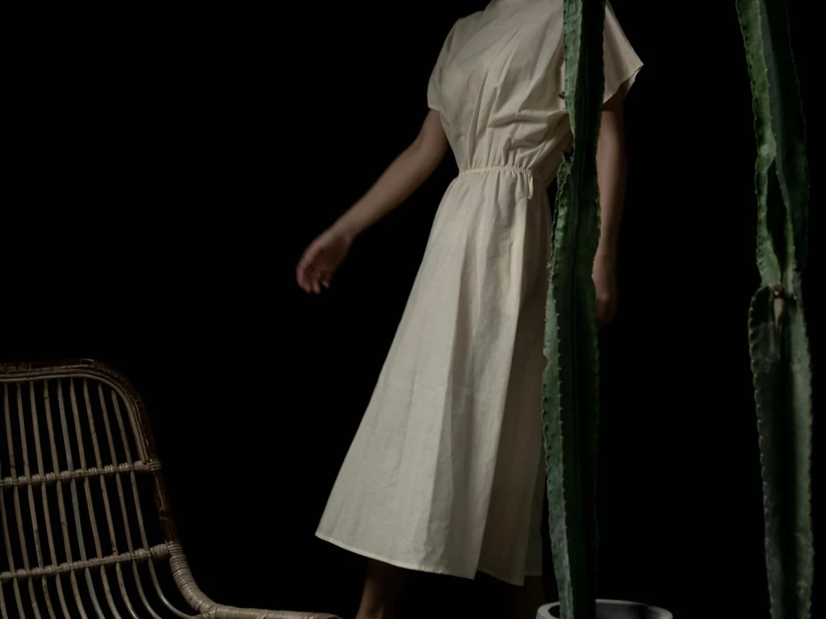 Representative plus-size fashion photography for the fictional product Room Relaxed Midi Dress