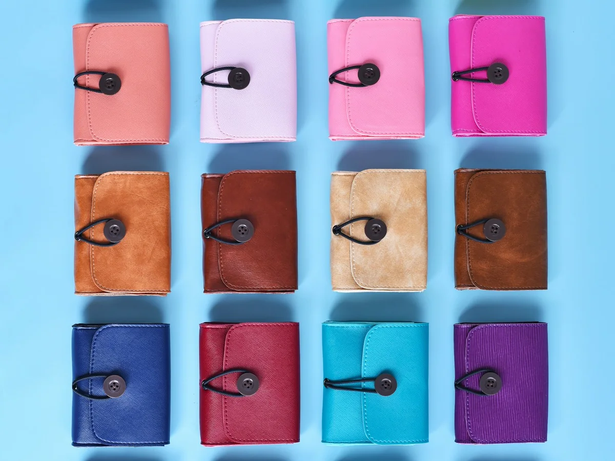 Representative wallets and leather goods photography for the fictional product Hand-stitched Everyday Wallet