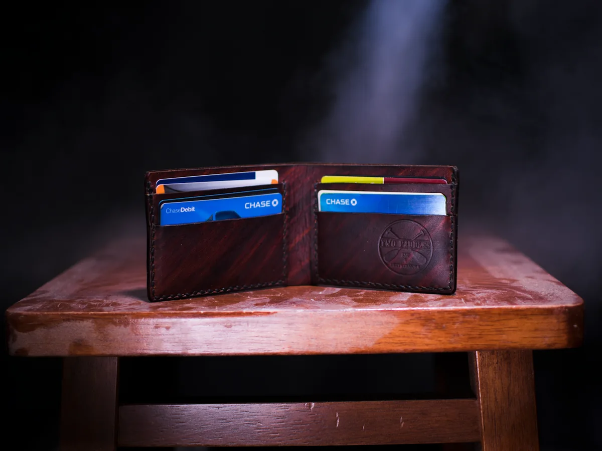Representative wallets and leather goods photography for the fictional product Burgundy Billfold